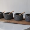 Volcanic stone condiment set with wooden tray