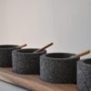 Volcanic stone condiment set with wooden tray